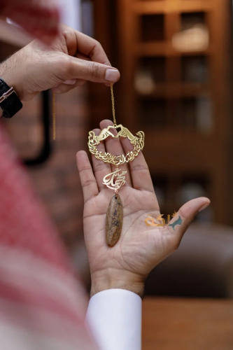 A car pendant plated with gold or silver with oud...