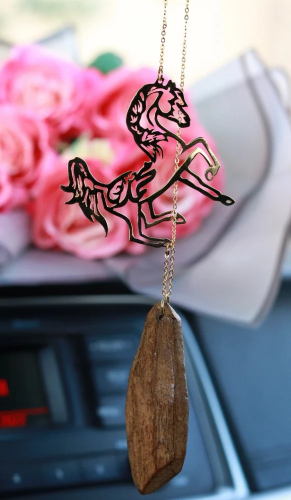 A car pendant plated with gold or silver with oud...