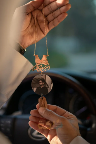 A car pendant plated with gold or silver with oud engraved with the name according to your request