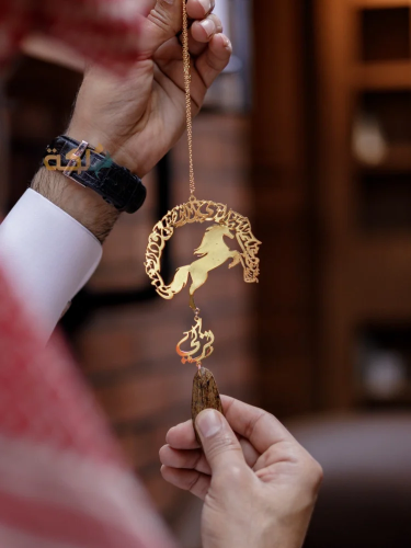 A car pendant plated with gold or silver with oud...