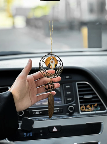 A car pendant coated with gold or silver with oud...