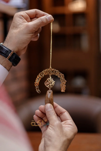 A car pendant plated with gold or silver with oud...