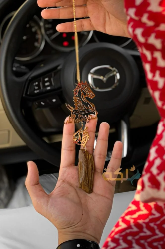 A car pendant plated with gold or silver with oud...