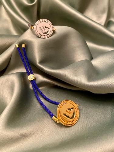 A string bracelet plated with gold or silver