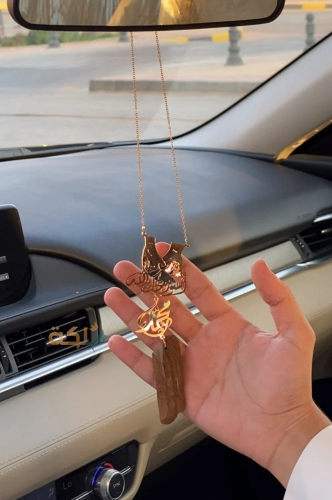 A car pendant plated with gold or silver with oud...