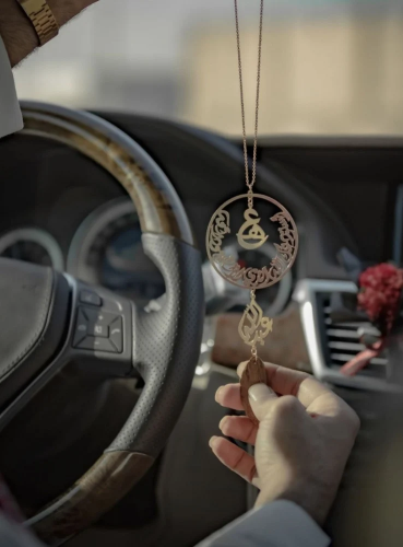 A car pendant plated with gold or silver with oud...