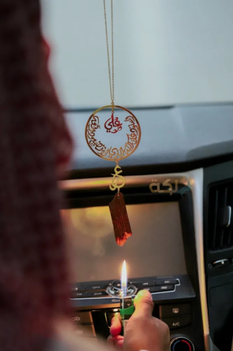 A car pendant plated with gold or silver with oud...