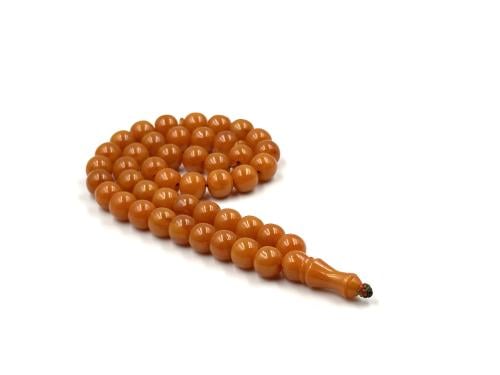 A German bakelite rosary, apricot color, with a bloody vein pattern, an old cast iron piece, made by Shaaban, may God have mercy o...