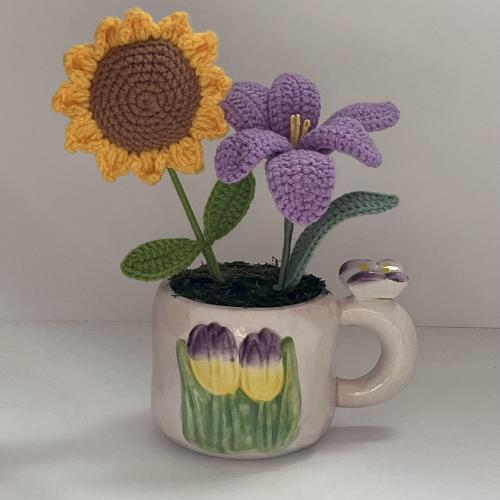 The cup of the violet flowers and the sunflower