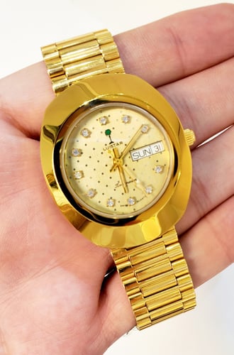 ساعة لوستار السويسرية ( فنتج ) بتاريخين رسم النخلة...