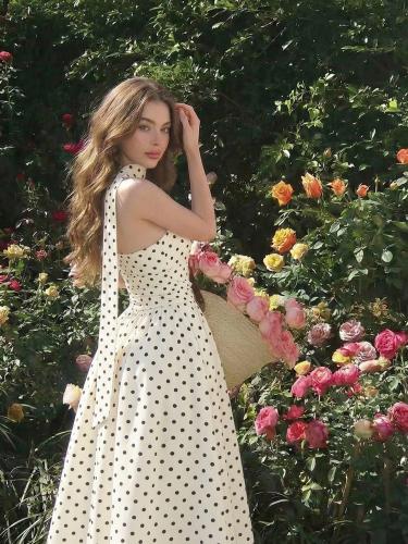 Medium-length sleeveless dress with polka dot patt...