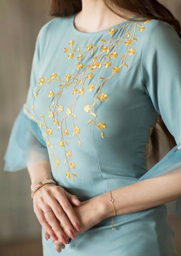 Sky-colored dress embroidered with gold