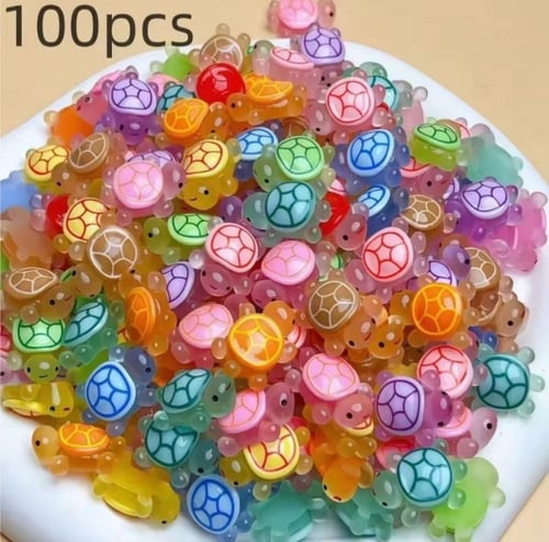 سلاحف بلاستيكية صغيرة وملونة، ذات أصداف شفافة وعنا...