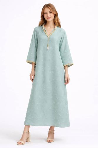Women's abaya, pistachio-colored, with delicate patterns and a loose fit, giving you comfort and distinctive daily elegance.