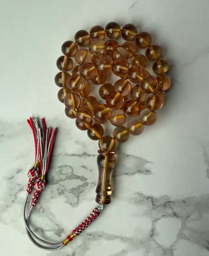 Transparent saffron prayer beads