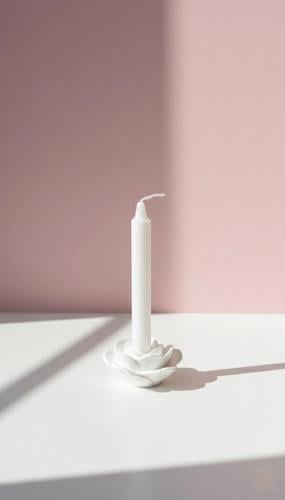 A candle with a flower base