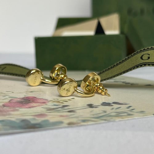 أقراط ذهبيه من قوتشي