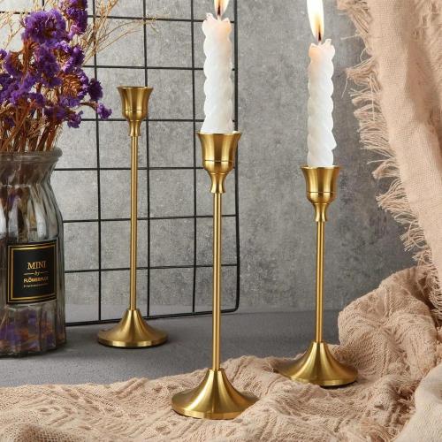 A set of 3 elegant antique candle holders made of metal and aluminum
