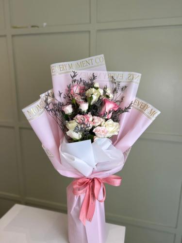 A bouquet of pink flowers with pink wrapping (Numb...