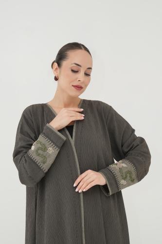 Linen abaya, crinkled, oily, with a tear from the sleeves