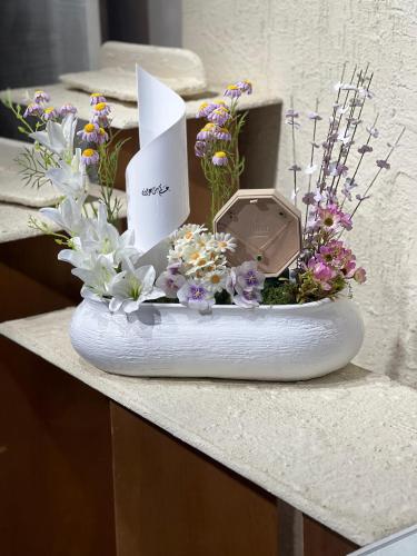 Flower vase with a necklace