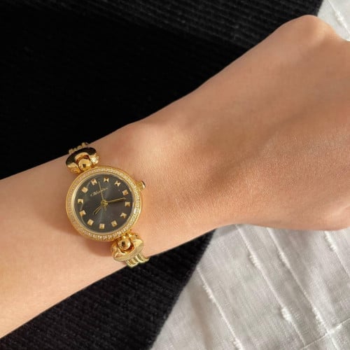 ساعة نسائية دائرية باللون الذهبي مينا أسود