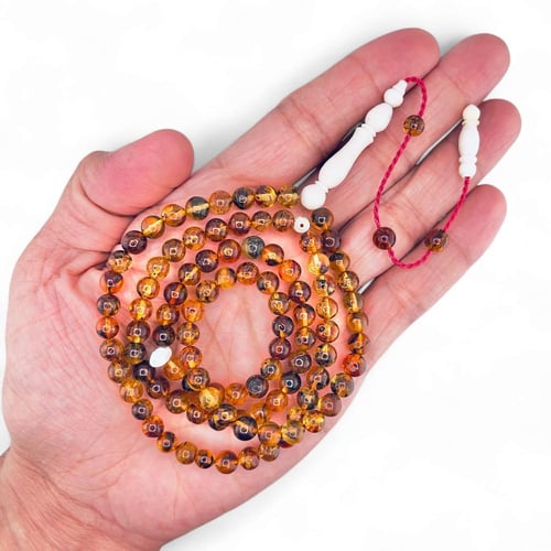 سبحة كهرمان بلطيقي طبيعي 99 خرزة بفواصل عظم الجمل...