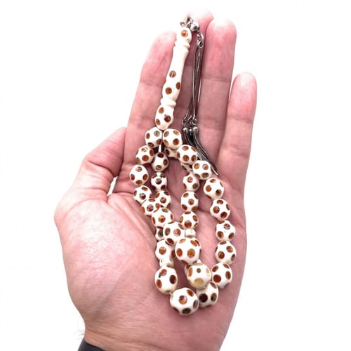 سبحة عاج مطعّم كهرمان