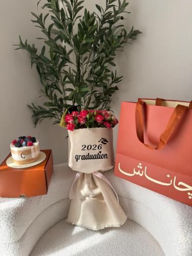 A bouquet of flowers with a graduation message and...