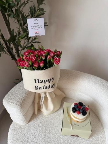 A bouquet of flowers with a ganache cake