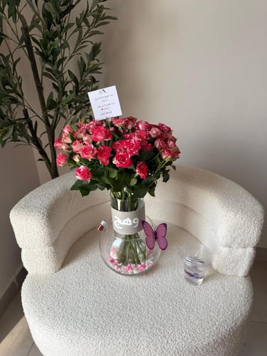Two vases of fish with natural roses and a printed...