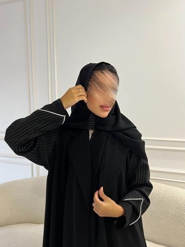 Black blazer with vertically striped fabric with a flared cut