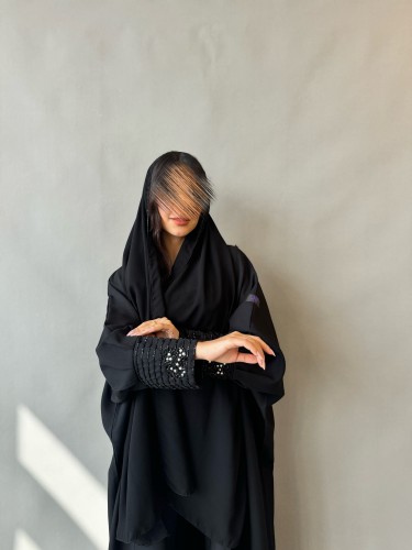A half abaya with a Beshte and hand embroidery on the sleeves