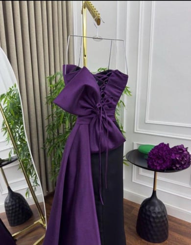فستان سهرة بنفسجي بتصميم درامي وذيل أنيق