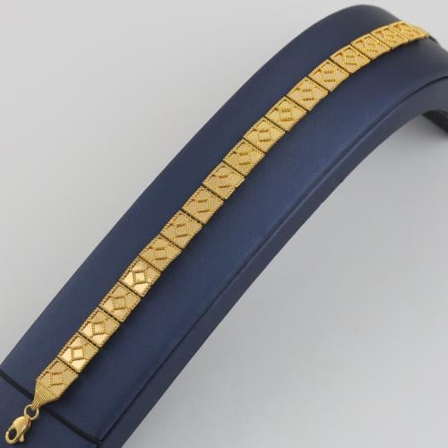 Gold bracelet with square patterns and dotted circ...