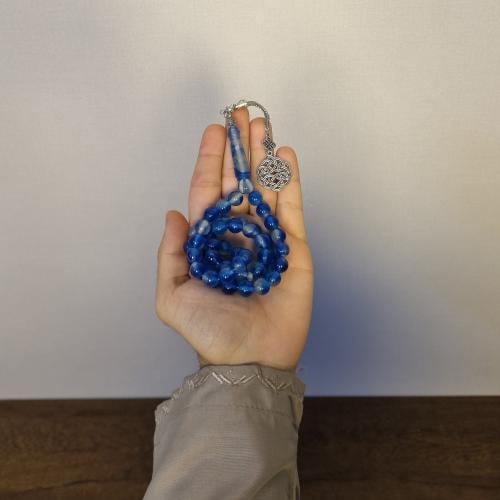 Blue 51-bead Tasbih in the dark oven