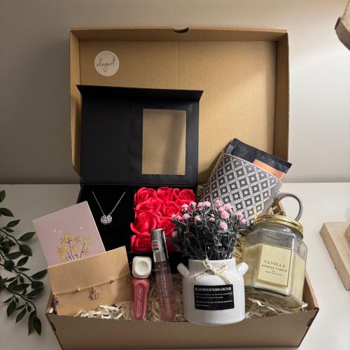 A gift containing: a box of red roses with a neckl...