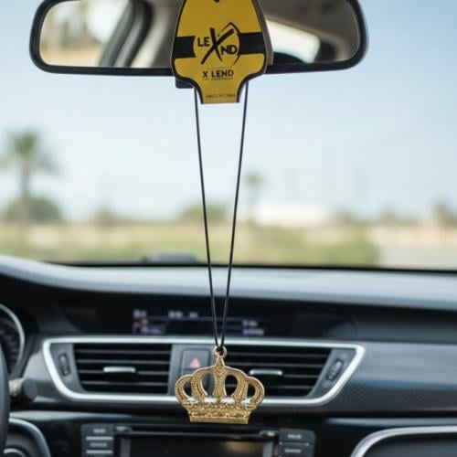 A metal crown pendant in two colors, gold and silv...