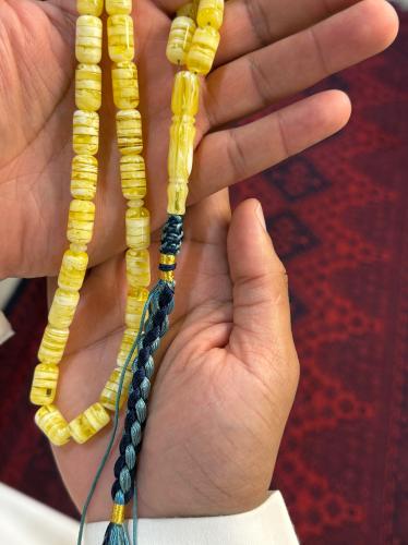 A cylindrical beaded rosary