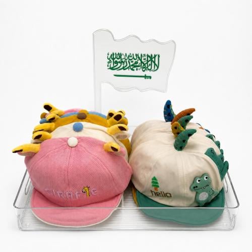 A distribution tray of the Clirk hats, stylish caps for children aged 1-5 years with the crocodile and giraffe characters, 12 piec...
