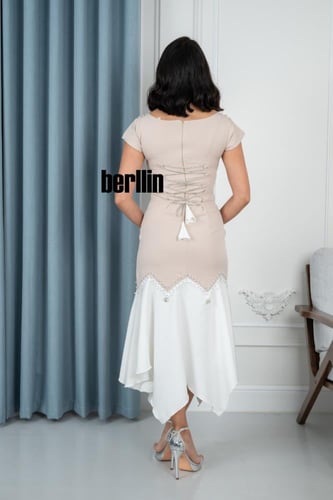 فستان سهره أنيق بتصميم غير متماثل ولمسات فاخرة ممي...