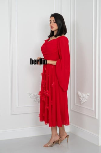 فستان أحمر أنثوي بتفاصيل ساحرة بتصميم درابيه