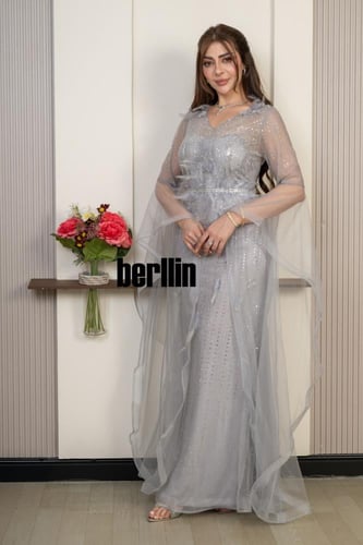 فستان سهرة فضي لامع بتصميم أنثوي وأكمام تول منسدلة