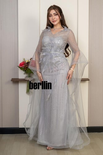 فستان سهرة فضي لامع بتصميم أنثوي وأكمام تول منسدلة