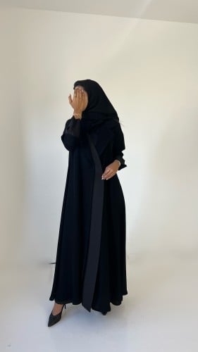 Black crepe abaya with a touch of dark gray in a f...