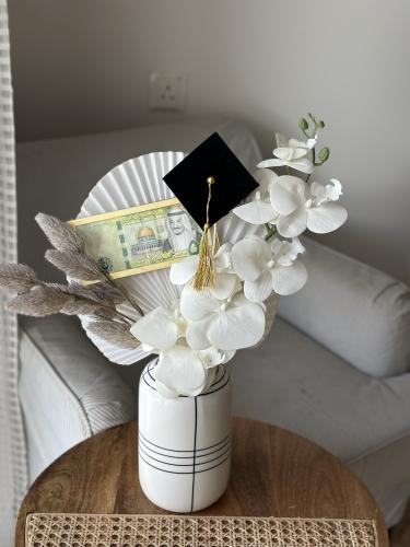 A graduation vase with a money holder