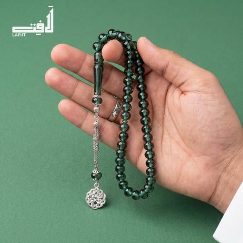 Transparent emerald-colored prayer bead with silve...