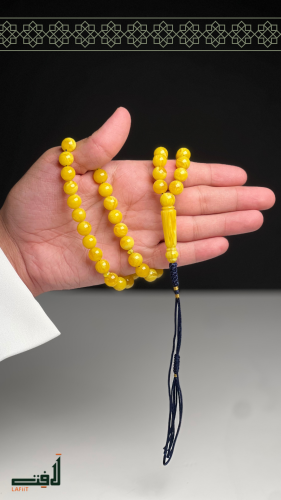 Yellow marble effect wallpaper with tassel detail