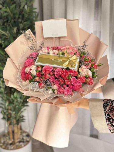 A bouquet of flowers and Bostani chocolate