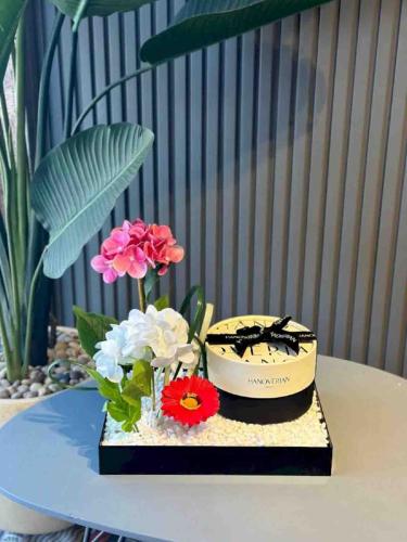 Artificial flower arrangement on acrylic with choc...
